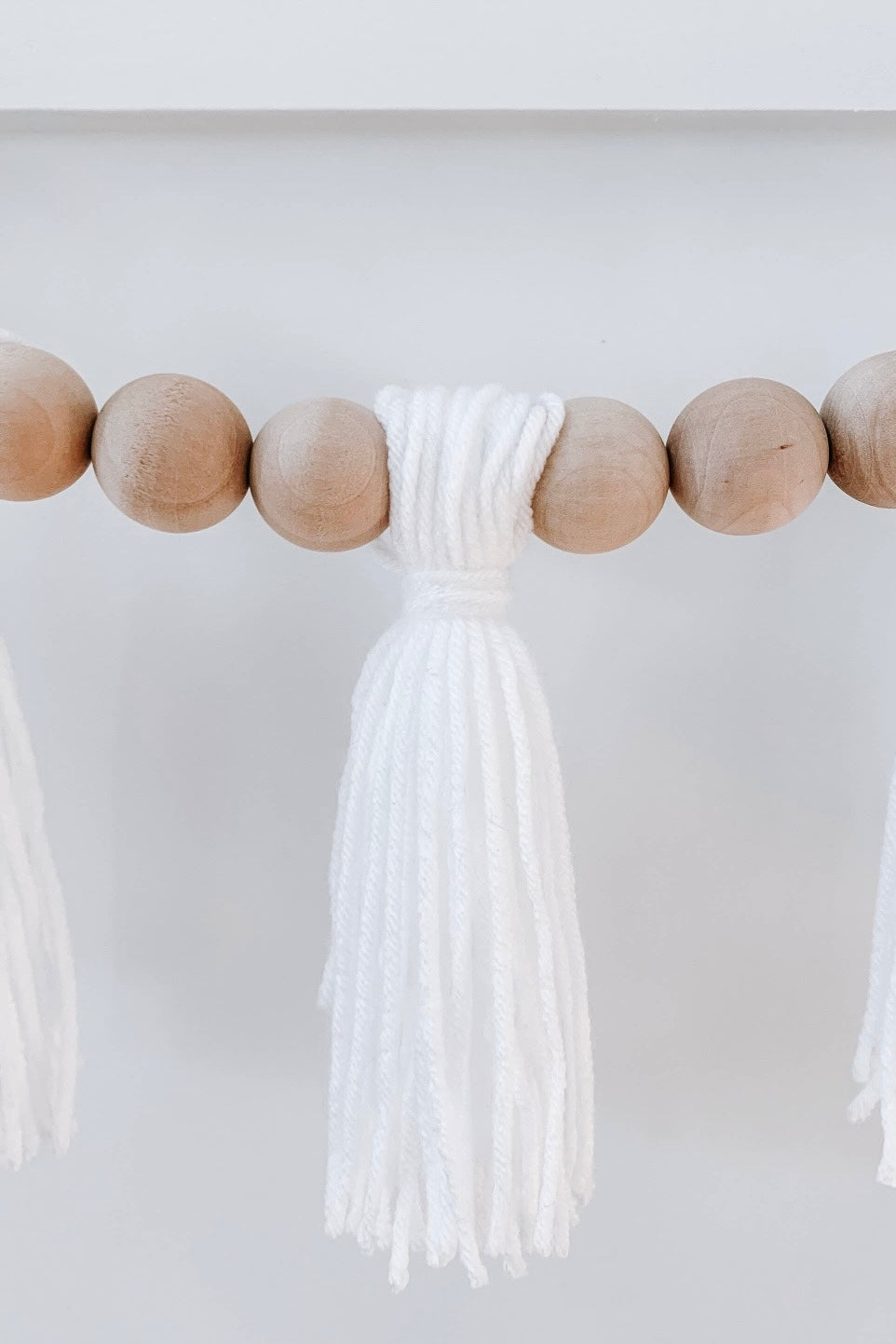 mode, wood beaded garland w yarn tassels