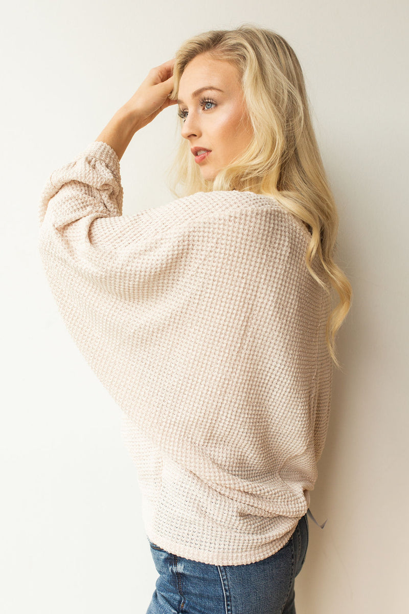 mode, with open arms sweater