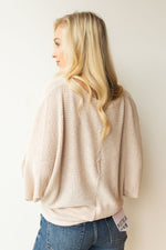 mode, with open arms sweater