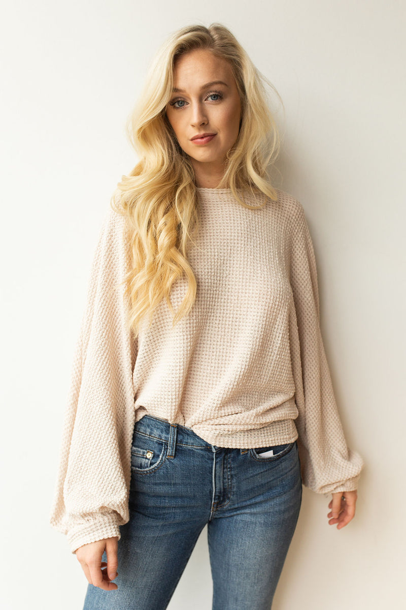 mode, with open arms sweater