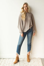mode, with open arms sweater