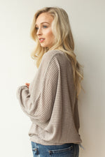 mode, with open arms sweater