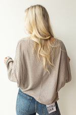 mode, with open arms sweater