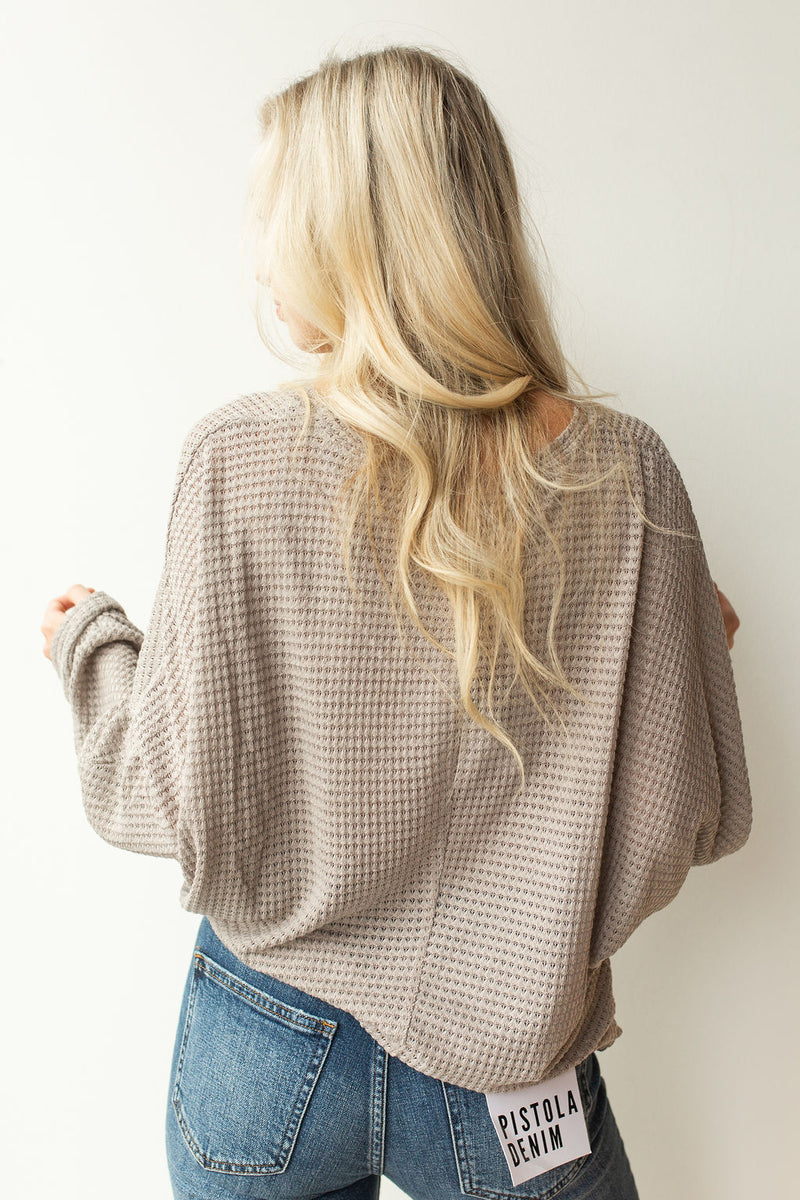 mode, with open arms sweater