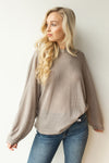 mode, with open arms sweater