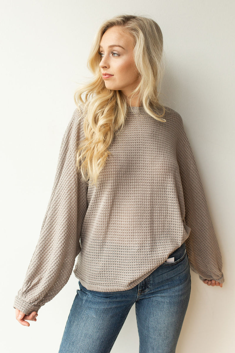 mode, with open arms sweater